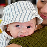 Beckham joined the competition — help win amazing prizes! adult, affection, baby, close_up, cuddle, eyes, face, family, green_sweater, holding, indoor, infant, mother, photography, portrait, safe, smiling, soft_lighting, striped_clothing, sunhat