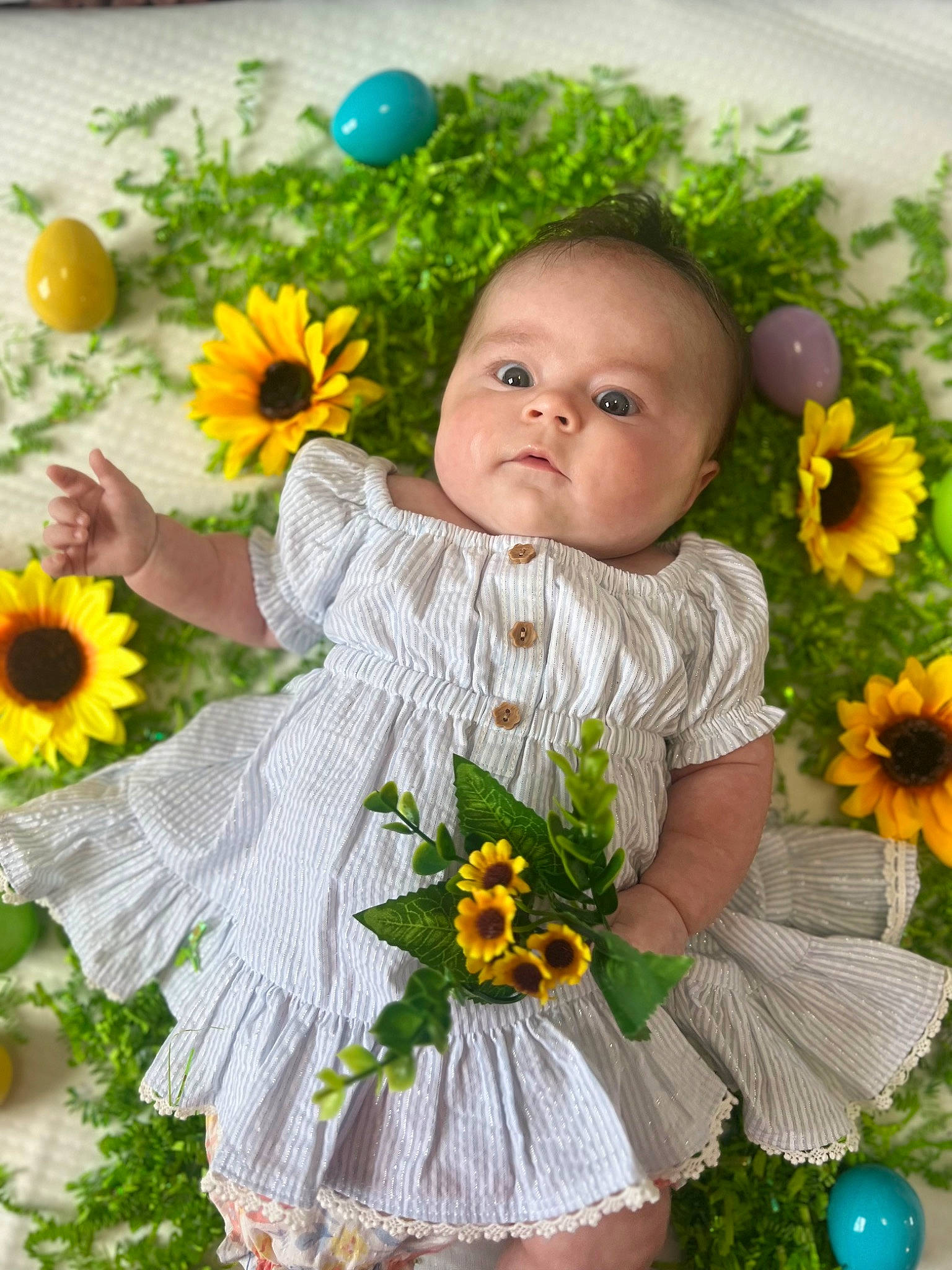 Brooklynn is registered to the contest to win money with this photo: baby_toddler_clothing, botany, facial_expression, flower, flower_arranging, grass, green, happy, iris, leaf, meadow, nature, orange, people_in_nature, person, petal, photograph, plant, summer, toddler