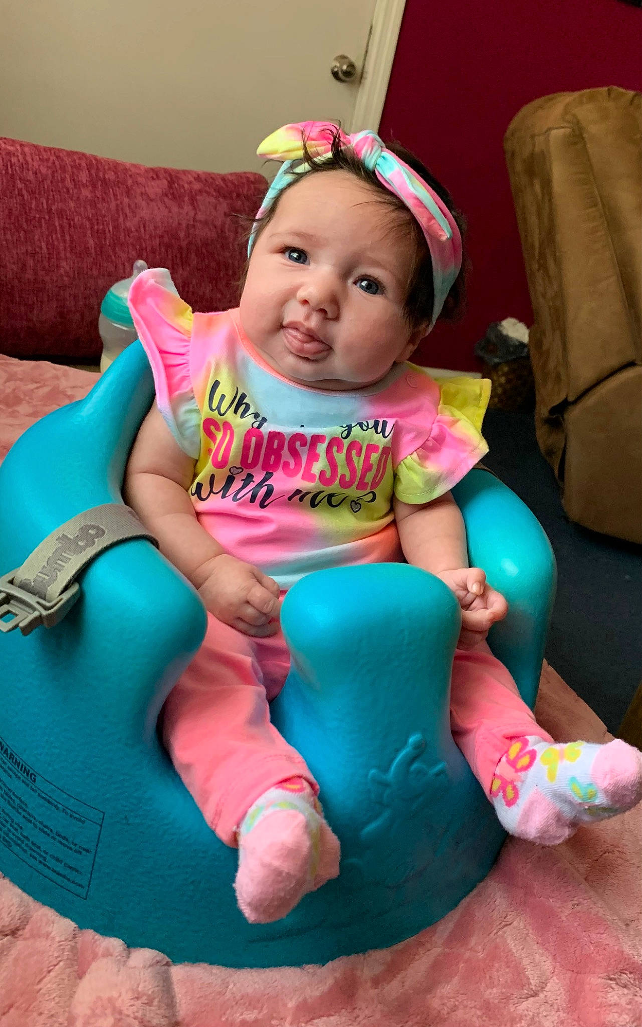 Amelia joined the competition — help win amazing prizes! aqua, baby, baby_toddler_clothing, chair, child, comfort, dress, eye, fun, happy, headwear, human_body, leisure, magenta, person, pink, purple, sitting, skin, sock