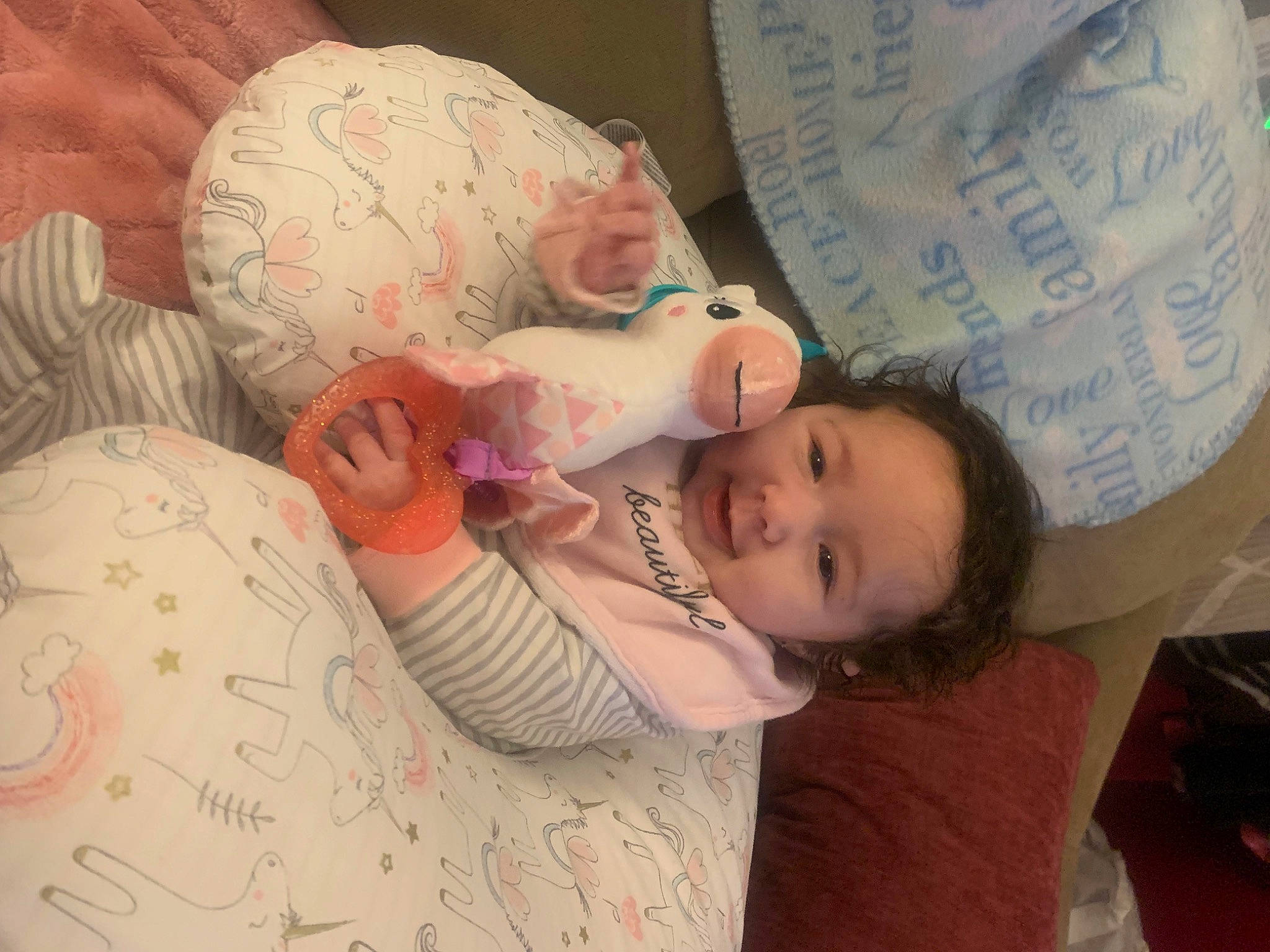 Amelia is registered to the contest to win money with this photo: baby, baby_toddler_clothing, cheek, child, comfort, finger, handwriting, happy, hat, linens, mouth, nail, nose, people, person, pink, room, skin, smile, textile