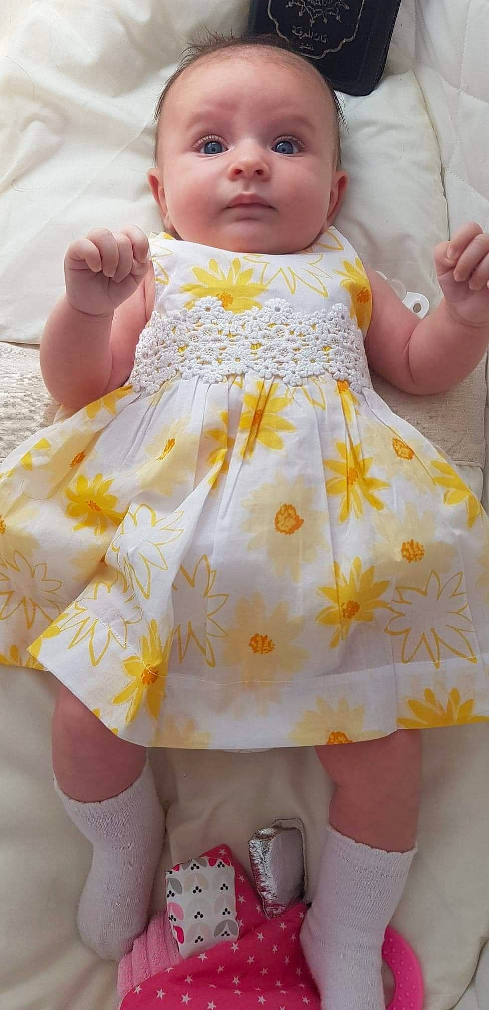 Elyna participe au concours pour gagner de l'argent avec cette photo : baby, cheek, child, doll, dress, pattern, person, toddler, toy, yellow