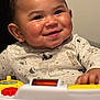 Jeremiah joined the competition — help win amazing prizes! baby, child, smiling, face, cheeks, toy, onesie, animal_pattern, hand, indoor, cute, happy, infant, play, young, person, portrait, closeup, skin, clothing