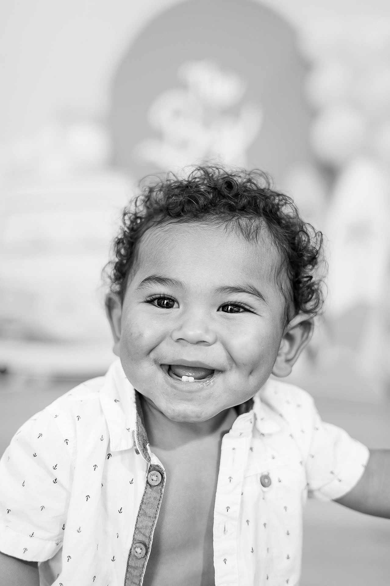 Jeremiah is registered to the contest to win money with this photo: child, toddler, smile, curly_hair, dimples, white_shirt, buttoned_shirt, face, portrait, happy, cute, black_and_white, indoor, closeup, person, young_child, expression, baby_teeth, background_blur, light