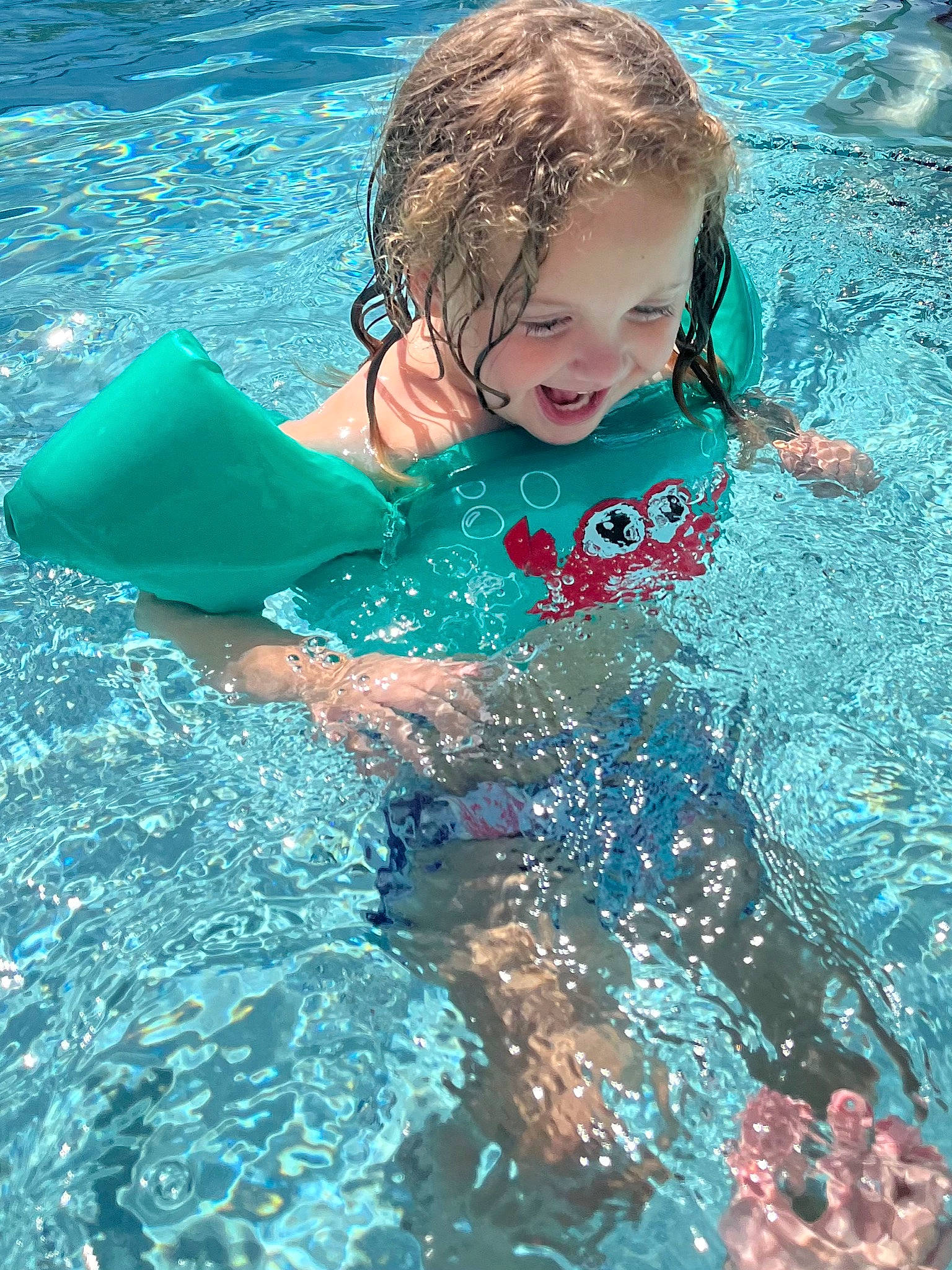 Sailor is registered to the contest to win money with this photo: aqua, azure, bathing, child, face, fun, hair, happy, head, joy, leisure, outdoor_recreation, people_in_nature, person, personal_protective_equipment, recreation, smile, summer, swimmer, swimming_pool