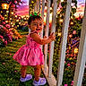 toddler, child, pink_dress, purple_shoes, fence, garden, flowers, fairy_lights, sunset, grass, smiling, cute, outdoor, nature, greenery, happy, portrait, baby, plants, evening