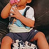 Jay'Ceon is registered to the contest to win money with this photo: toddler, child, sneakers, toy, couch, leather, sitting, curious, clothing, footwear, indoor, portrait, baby, casual, cute, person, young_child, shorts, shirt, sock