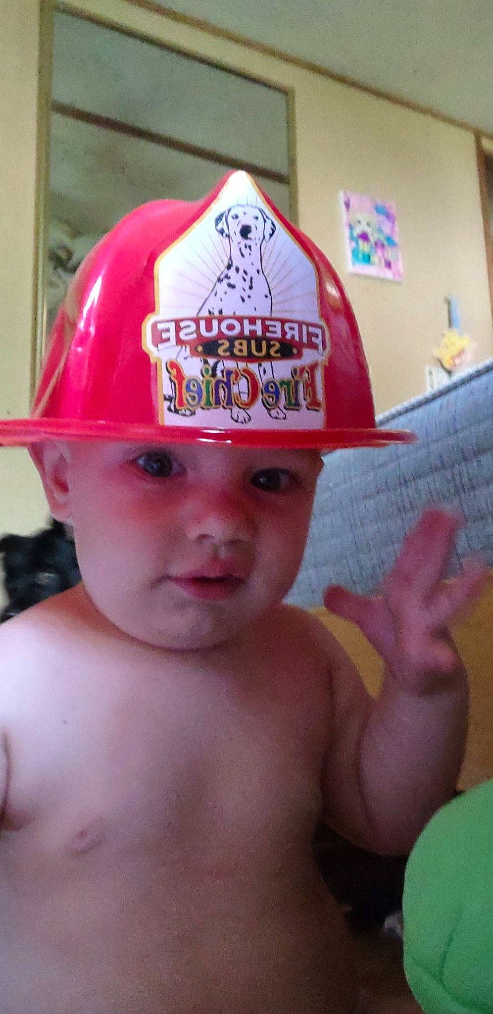 Marshall is registered to the contest to win money with this photo: baby, barechested, baseball_cap, cap, chest, child, fashion_accessory, fun, hat, headgear, headwear, human_body, leisure, person, personal_protective_equipment, product, recreation, room, throat, thumb