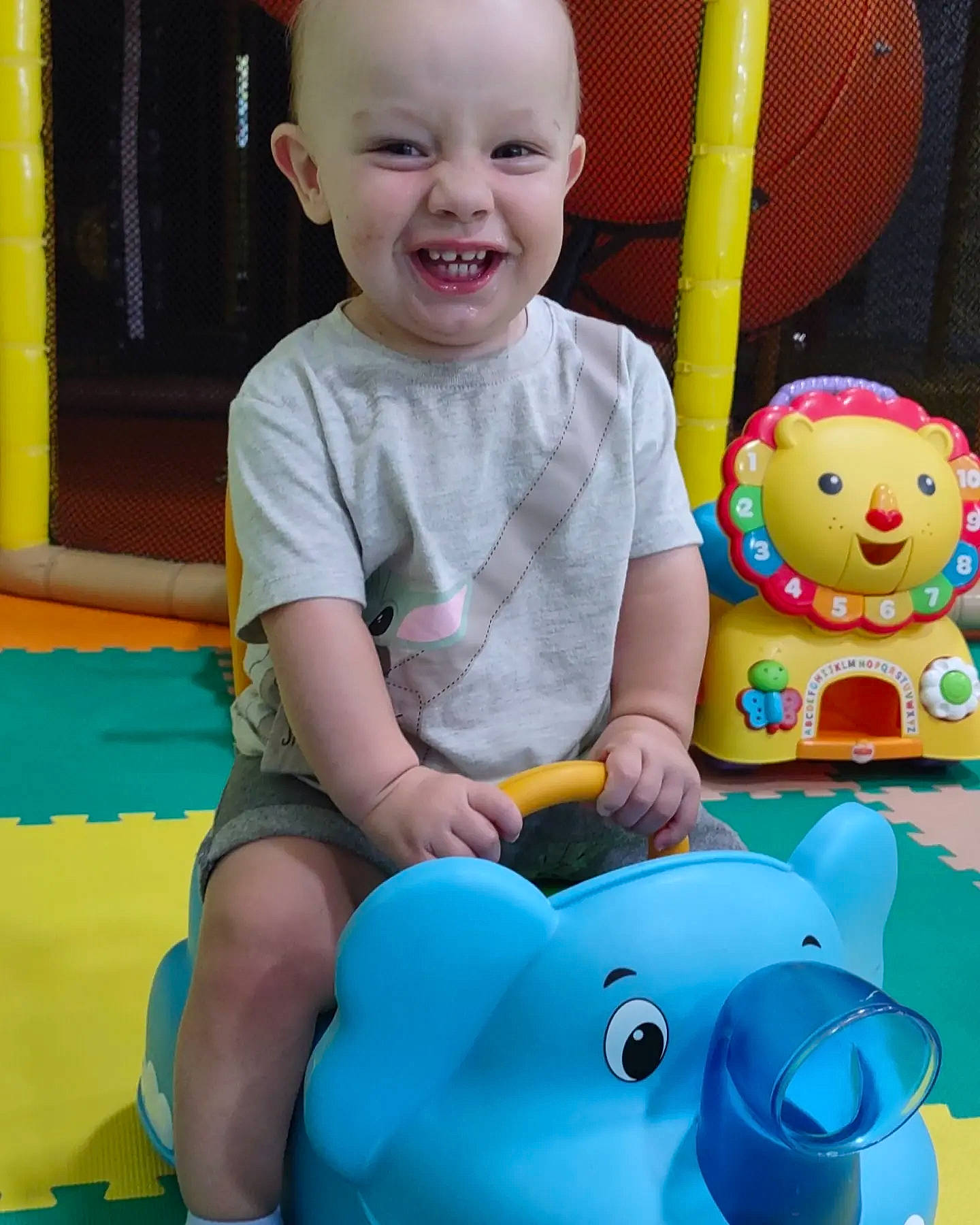 Marshall is registered to the contest to win money with this photo: baby, baby_playing_with_toys, baby_toddler_clothing, blue, facial_expression, fun, green, happy, head, leisure, organ, person, photograph, pink, product, shorts, skin, smile, toddler, white