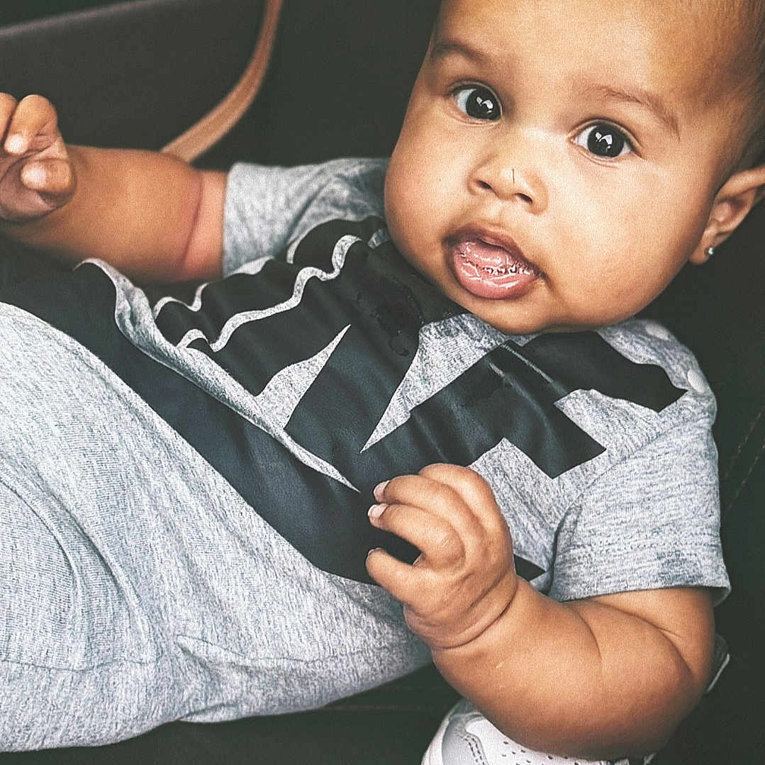 Jhamonni joined the competition — help win amazing prizes! baby, child, infant, sitting, clothing, shoes, sneakers, black_leather, gray_outfit, face, curious_eyes, earrings, hand, cute, portrait, indoor, young_child, expression, comfortable, casual