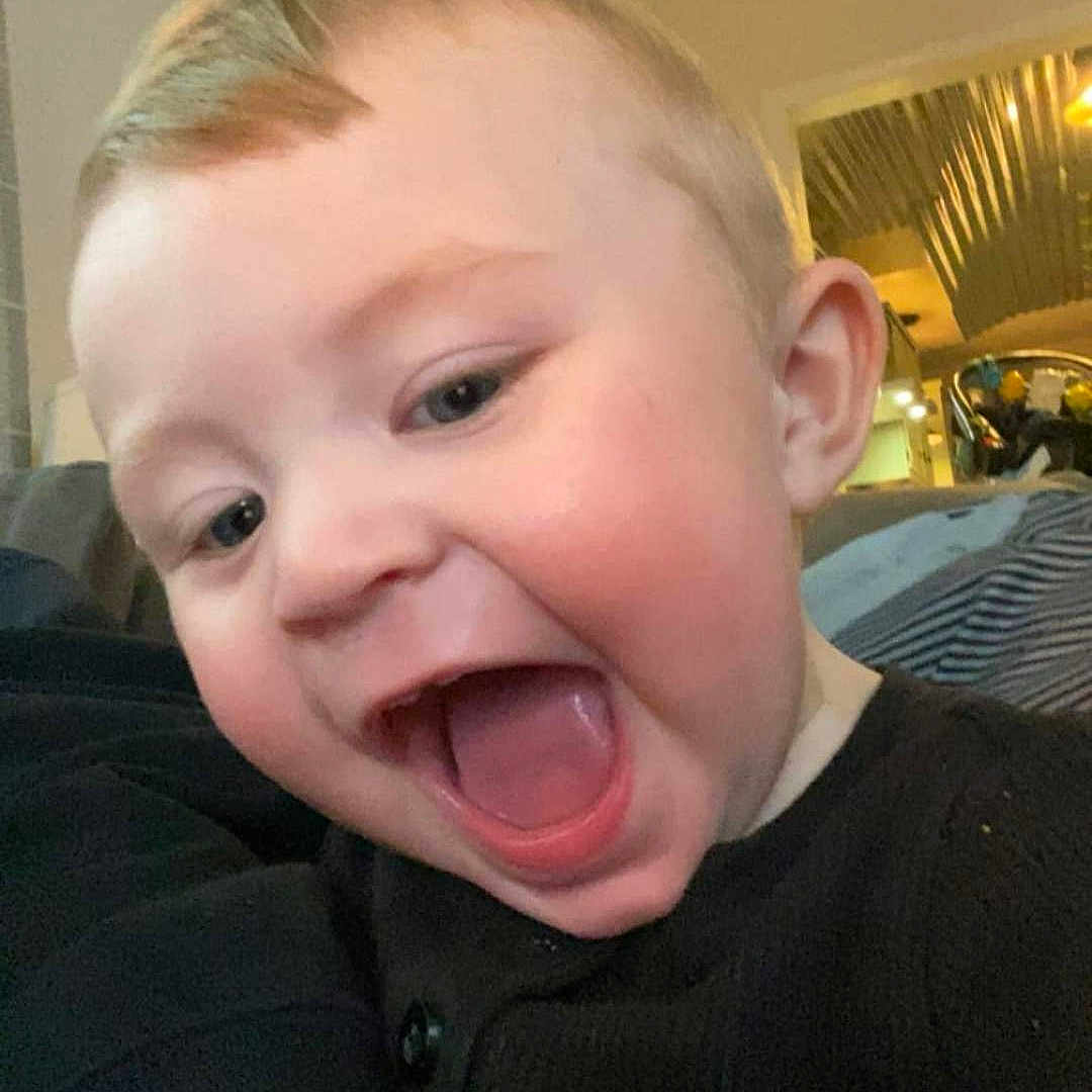 Sawyer is registered to the contest to win money with this photo: accessories, baby, babylaughing, bodypart, clothing, face, happy, head, indoors, jewelry, laughing, lighting, mouth, necklace, person, photography, portrait, selfie, t_shirt, teeth