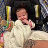 Noelle Ryann joined the competition — help win amazing prizes! baby, blanket, car_seat, child, clothing, cute, face, grocery_store, hand, happy, holding, indoor, infant, person, seat, shopping, shopping_cart, smiling, tattoo, toy