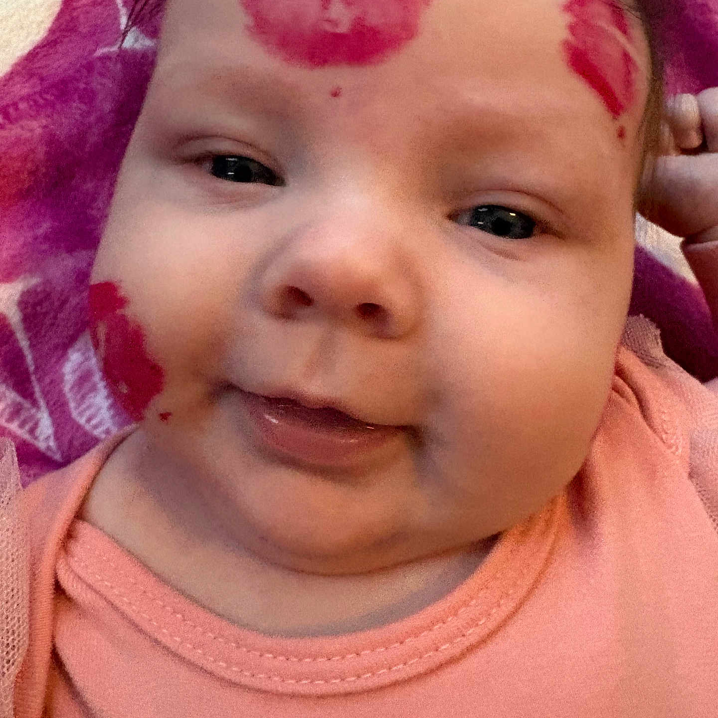 Noelle Ryann is registered to the contest to win money with this photo: adorable, baby, chubby_cheeks, close_up, cute, expression, face, head, infant, kiss_marks, lipstick, lying_down, peach_clothing, person, pink_blanket, portrait, red_marks, skin, toddler, young_child