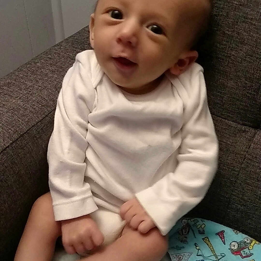 Apollo is registered to the contest to win money with this photo: cheek, child, day, eye, girl, head, infant, iris, leg, person, product, sitting, skin, smile, toddler