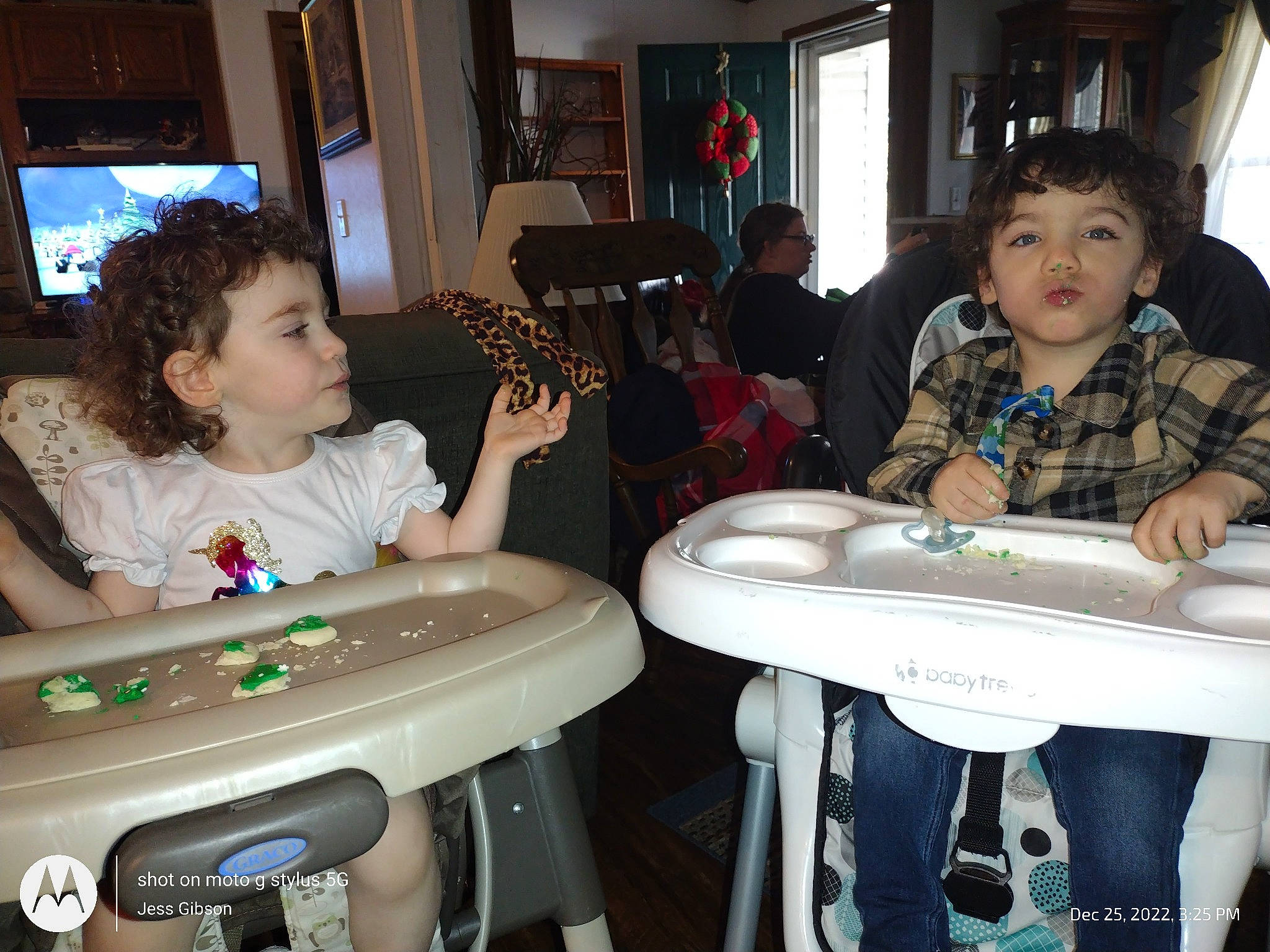 Jedidiah is registered to the contest to win money with this photo: arm, chair, child, event, fun, furniture, gadget, games, houseplant, input_device, lap, person, recreation, remote_control, room, sharing, sitting, t_shirt, table, television