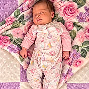 Stormie joined the competition — help win amazing prizes! baby, newborn, sleeping, infant, portrait, floral_blanket, quilt, pink, purple, cream, pajamas, onesie, indoors, lying_down, peaceful, closed_eyes, face, hands, feet, cozy