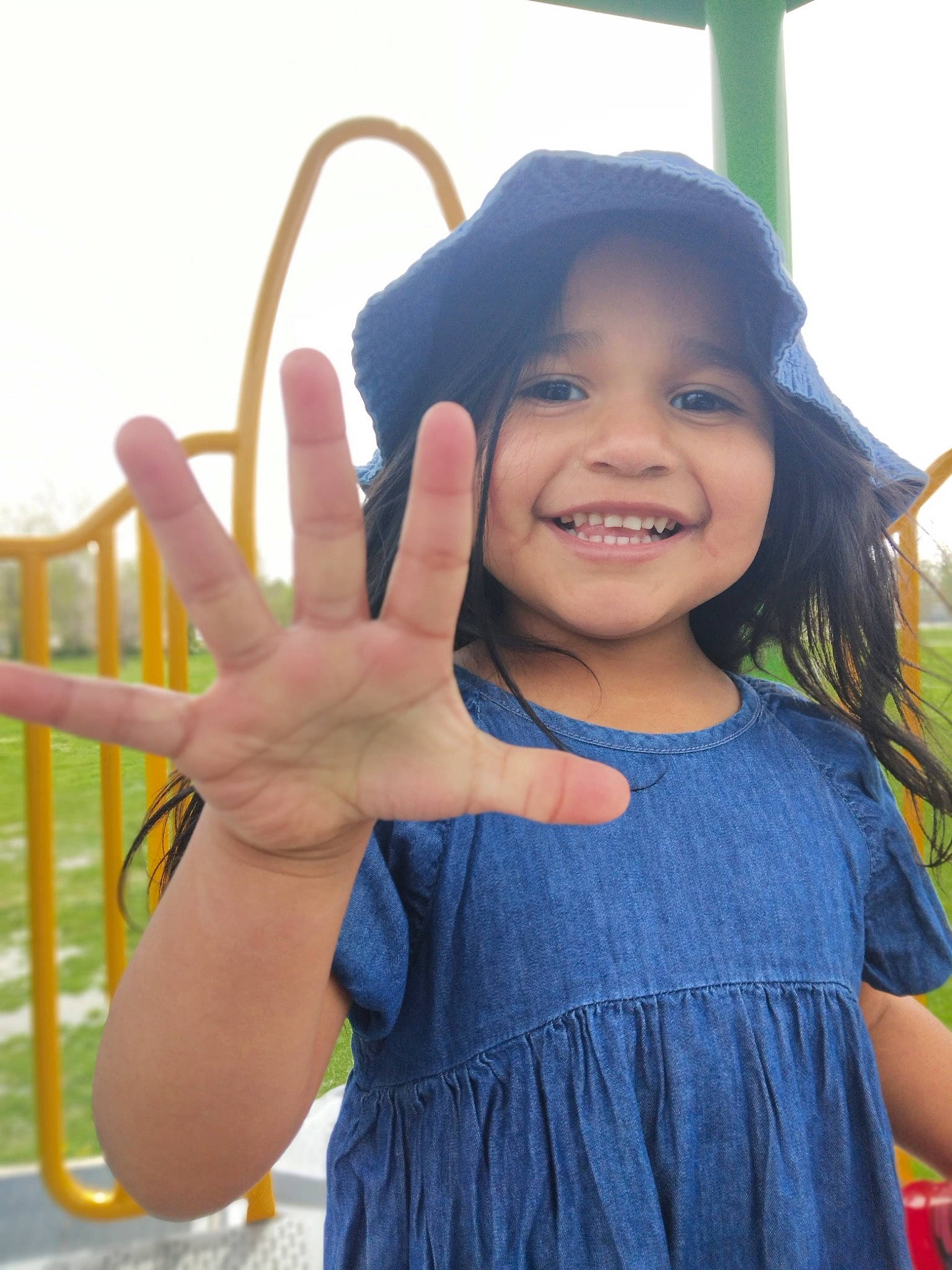 Miriam is registered to the contest to win money with this photo: child, cool, electric_blue, facial_expression, finger, fun, gesture, happy, joy, leisure, long_hair, neck, person, shoulder, skin, sky, sleeve, smile, standing, thumb