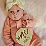Ezlynn joined the competition — help win amazing prizes! baby, infant, one_month, headband, bow, pink_clothing, blanket, portrait, cute, newborn, soft_texture, sleepwear, lying_down, indoors, child, person, milestone, wooden_sign, hand, face