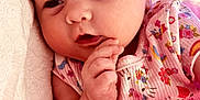 Ezlynn joined the competition — help win amazing prizes! baby, infant, child, pink_clothing, headband, cute, soft_texture, hand, face, portrait, lying_down, colorful, patterned_clothing, close_up, newborn, toddler, sleepy_eyes, baby_girl, soft_light, adorable
