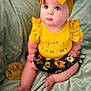 Ezlynn joined the competition — help win amazing prizes! baby, child, infant, yellow_headband, yellow_shirt, floral_skirt, pouty_lips, blue_eyes, sitting, blanket, milestone_marker, soft_texture, cute, portrait, indoor, clothing, adorable, chubby_legs, headwear, curious_expression