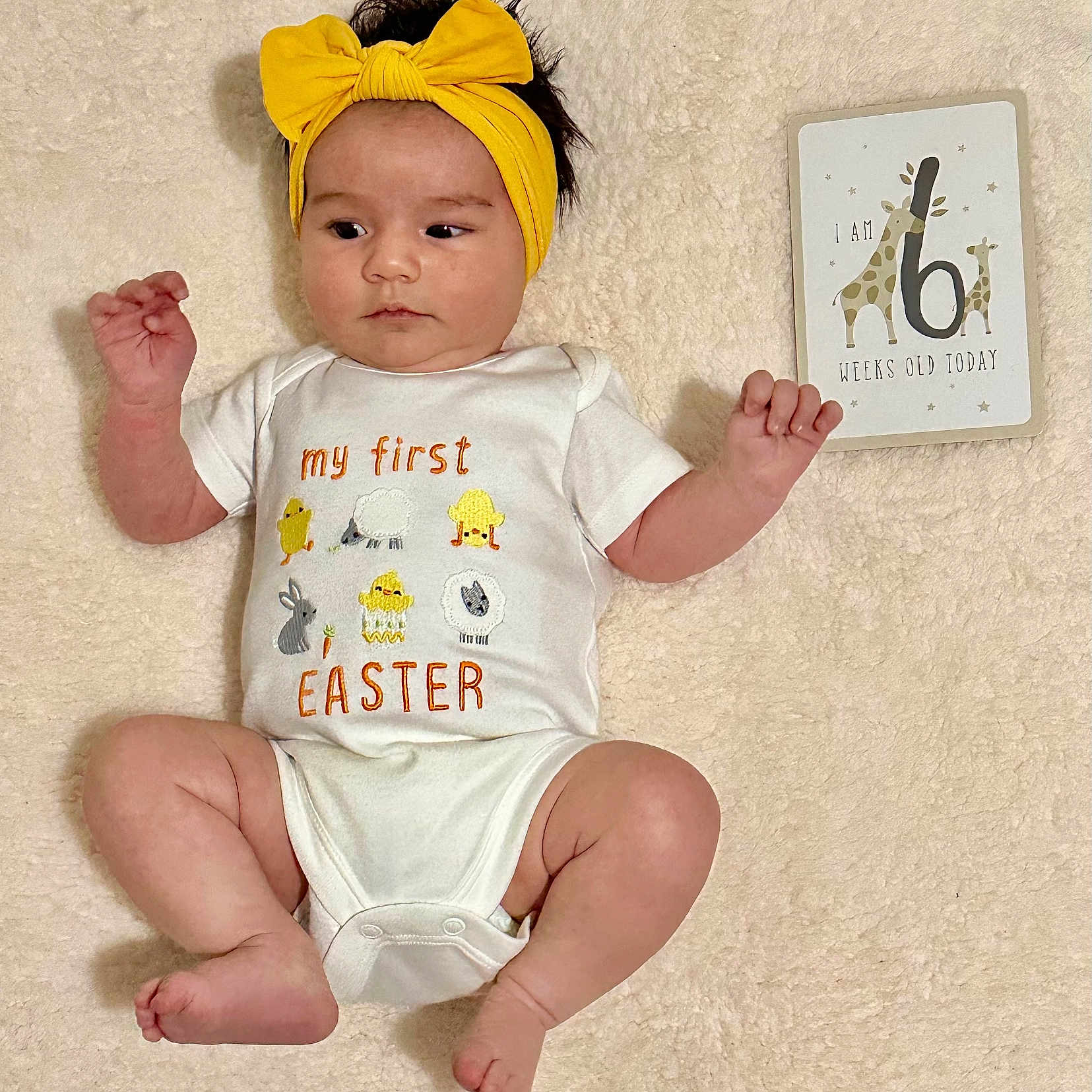 Loretta joined the competition — help win amazing prizes! 6_weeks_old, baby, blanket, card, celebration, child, chubby, cute, easter, headband, indoors, infant, lying_down, milestone, newborn, onesie, portrait, smiling, soft, yellow