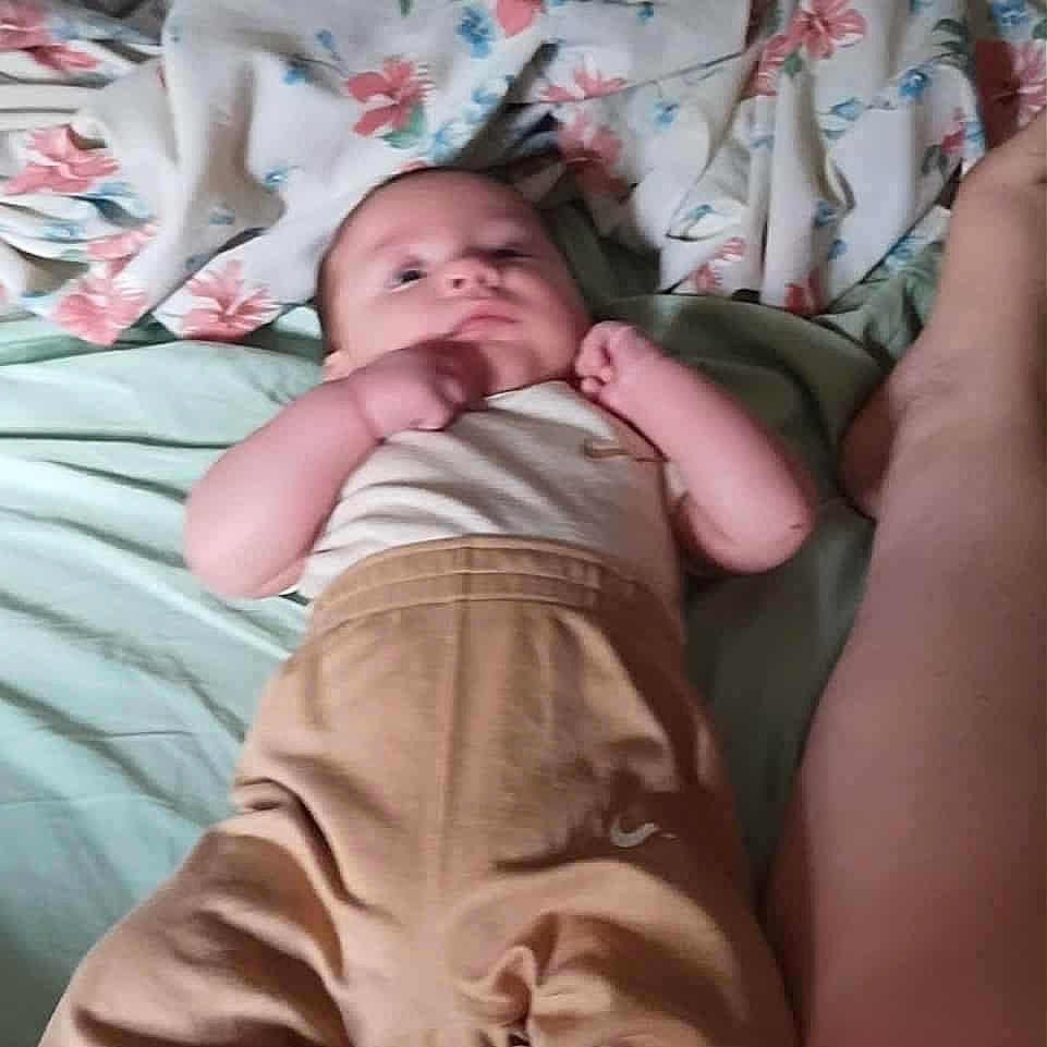 Dustin Lee Willis is registered to the contest to win money with this photo: baby, bed, blanket, child, clothing, cozy, cute, floral_pattern, foot, human, indoor, infant, leg, lying_down, pants, person, resting, skin, sleepwear, top