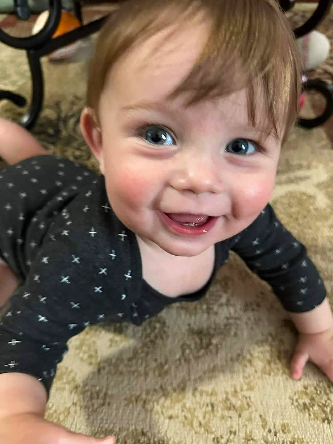 Cecil is registered to the contest to win money with this photo: baby, baby_toddler_clothing, cheek, child, eyelash, flooring, fun, fur, happy, joy, laugh, motorcycle, nose, pattern, person, play, sitting, skin, smile, thumb