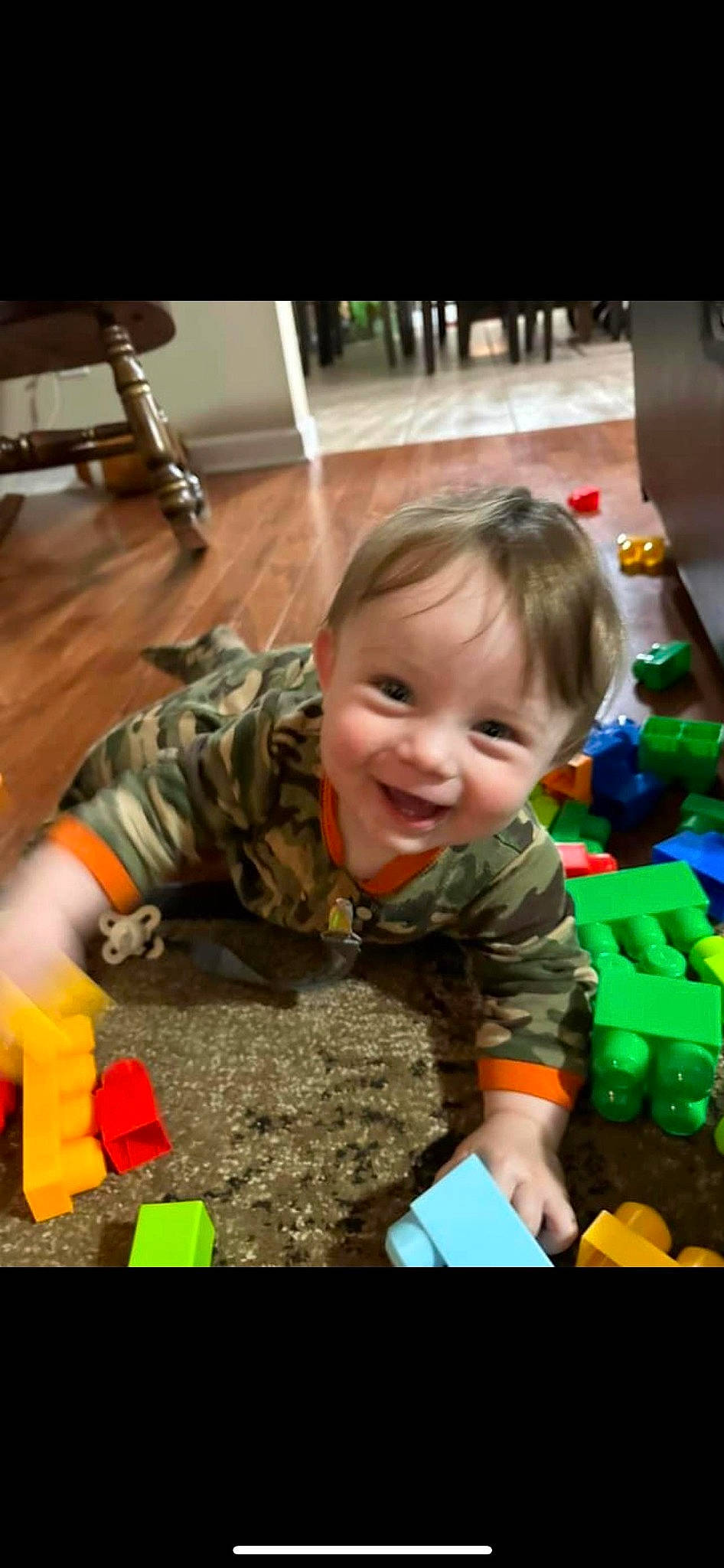 Cecil is registered to the contest to win money with this photo: baby, baby_toddler_clothing, baby_toys, child, crawling, flooring, fun, grass, happy, joy, laugh, leisure, person, play, room, sitting, smile, soil, toddler, toy