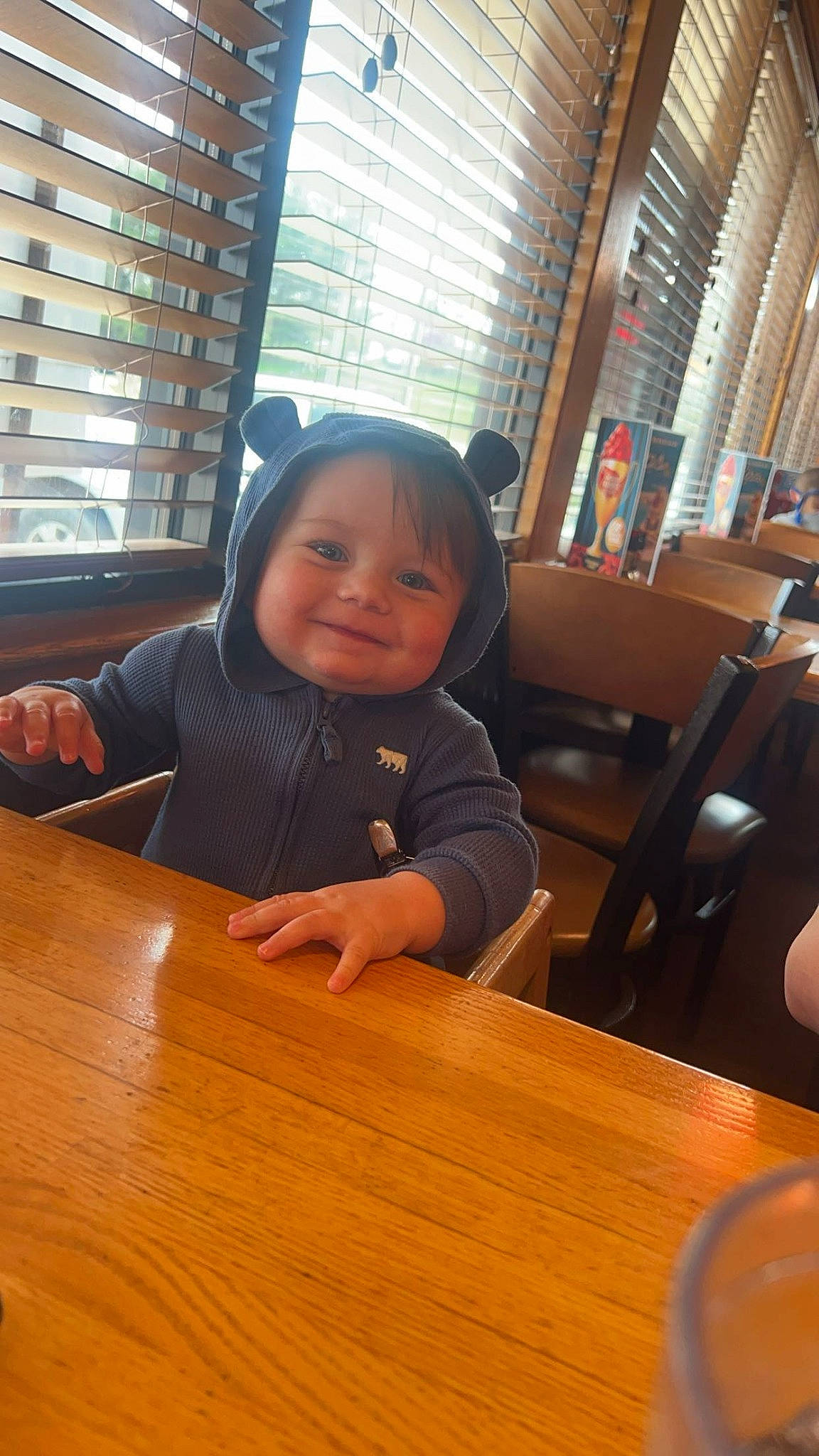 Cecil joined the competition — help win amazing prizes! building, chair, child, desk, flooring, fun, furniture, hardwood, joy, kitchen_dining_room_table, person, room, sitting, smile, table, tableware, thumb, toddler, varnish, window