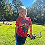 Ezekiel joined the competition — help win amazing prizes! child, boy, smiling, outdoor, grass, sunlight, super_mario, tshirt, shorts, shoes, playful, muddy_face, trees, daylight, nature, person, happy, casual_clothing, standing, backyard