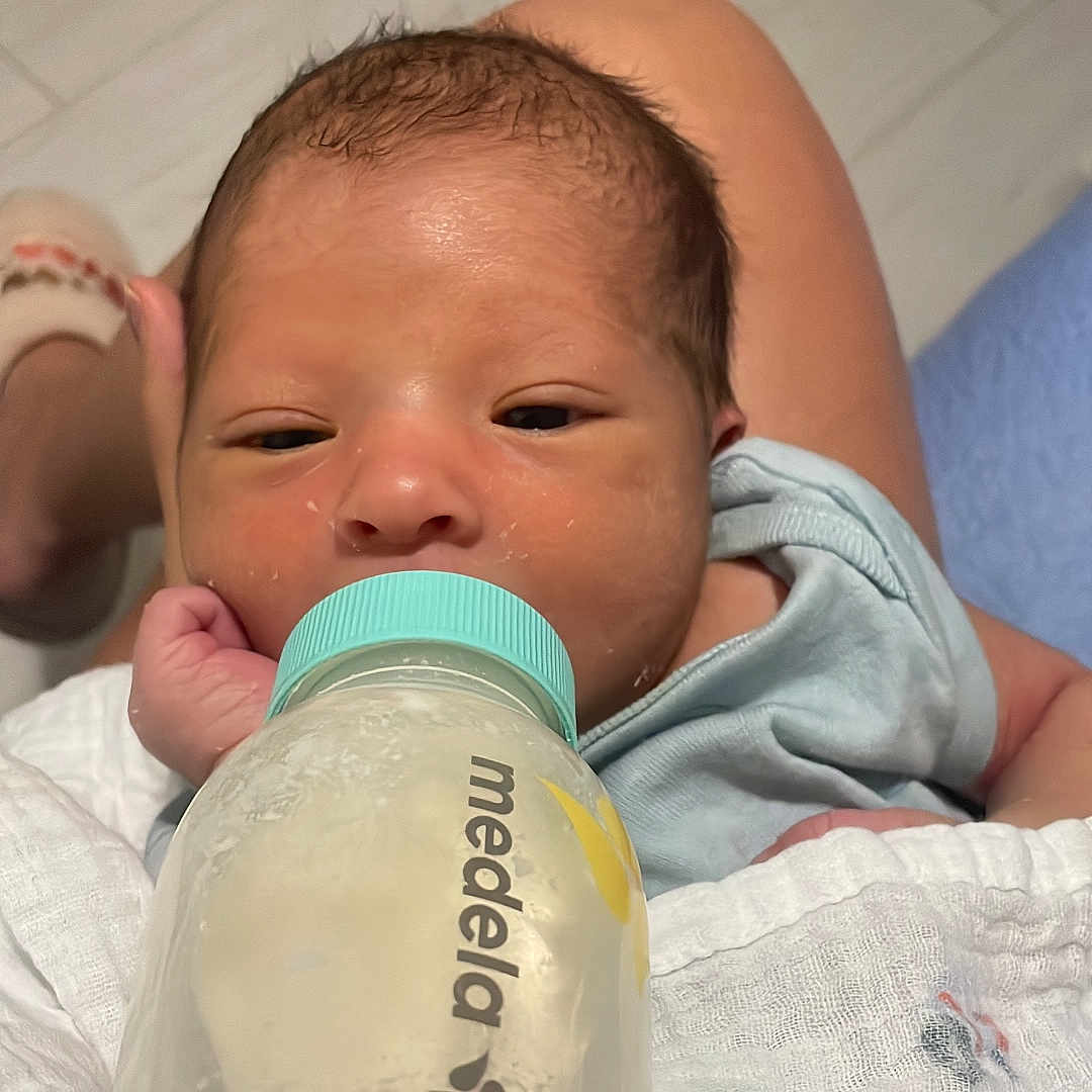 Liam joined the competition — help win amazing prizes! baby, blanket, bottle, car_print, closeup, clothing, feeding, floor, foot, hand, indoors, infant, milk, newborn, person, portrait, resting, skin, sleepy, tile