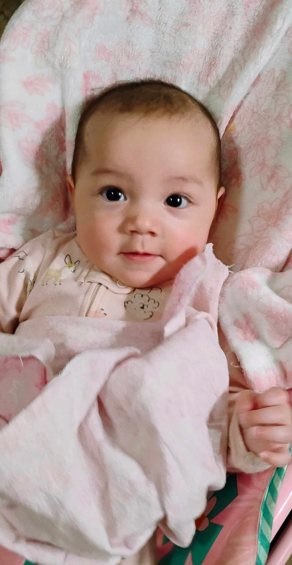 Ava is registered to the contest to win money with this photo: baby, infant, blanket, pink, face, eyes, hand, clothing, cute, child, soft, portrait, indoors, comfort, rest, newborn, person, sleepwear, fabric, warm