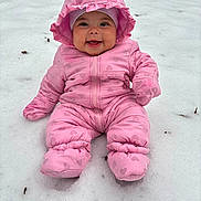 Alyza is registered to the contest to win money with this photo: baby, child, snow, pink_snowsuit, hood, mittens, boots, smile, happy, outdoor, winter, cold, sitting, cute, infant, frozen, playful, snowy_ground, warm_clothing, portrait