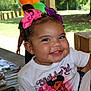 toddler, child, birthday, smile, bow, hair_accessory, outdoor, party, balloons, shirt, happy, face, person, cute, celebration, daylight, park, portrait, event, fun