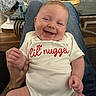 Kamdyn joined the competition — help win amazing prizes! baby, infant, child, smiling, happy, portrait, sitting, onesie, clothing, face, eyes, mouth, hands, legs, adult_lap, indoor, living_room, plants, furniture, family