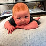 Kamdyn joined the competition — help win amazing prizes! baby, infant, child, portrait, close_up, face, eyes, wide_eyed, lying_down, tummy_time, hands, arms, blanket, soft_blanket, black_clothing, indoor, home, furniture, shelf, photography