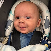 Braxton joined the competition — help win amazing prizes! baby, infant, car_seat, harness, blanket, pacifier, denim, smiling, wide_eyes, cheeks, face, head, portrait, close_up, safety_label, striped_sleeve, soft_blanket, newborn, button, cute