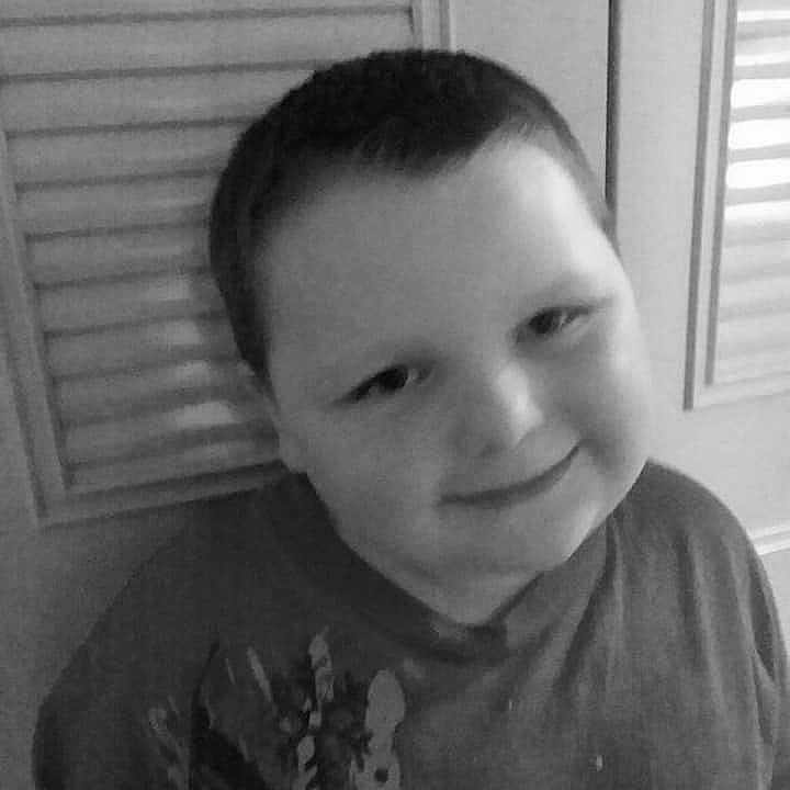 Chad is registered to the contest to win money with this photo: black, black_and_white, cheek, child, chin, day, eyebrow, face, facial_expression, forehead, hair, hairstyle, head, joy, monochrome_photography, nose, person, photograph, skin, smile