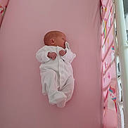 Summer is registered to the contest to win money with this photo: baby, newborn, crib, pink_mattress, onesie, pacifier, sleeping, infant, bed, bedding, child, soft, cute, peaceful, indoors, person, toddler, baby_clothes, resting, nursery