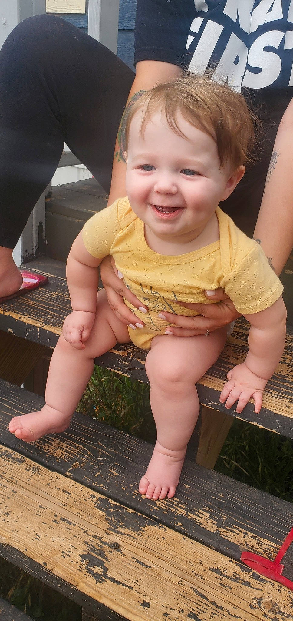 Lexie is registered to the contest to win money with this photo: baby_toddler_clothing, cheek, chin, eye, face, facial_expression, finger, grass, hairstyle, hand, head, iris, joy, leg, lip, mouth, nose, person, photograph, skin