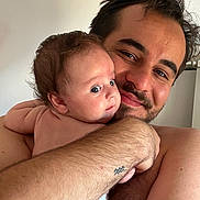 Mia participe au concours pour gagner de l'argent avec cette photo : affection, arm, baby, bond, child, closeup, expression, face, father, hair, hug, human, indoor, love, man, person, portrait, skin, smile, tattoo