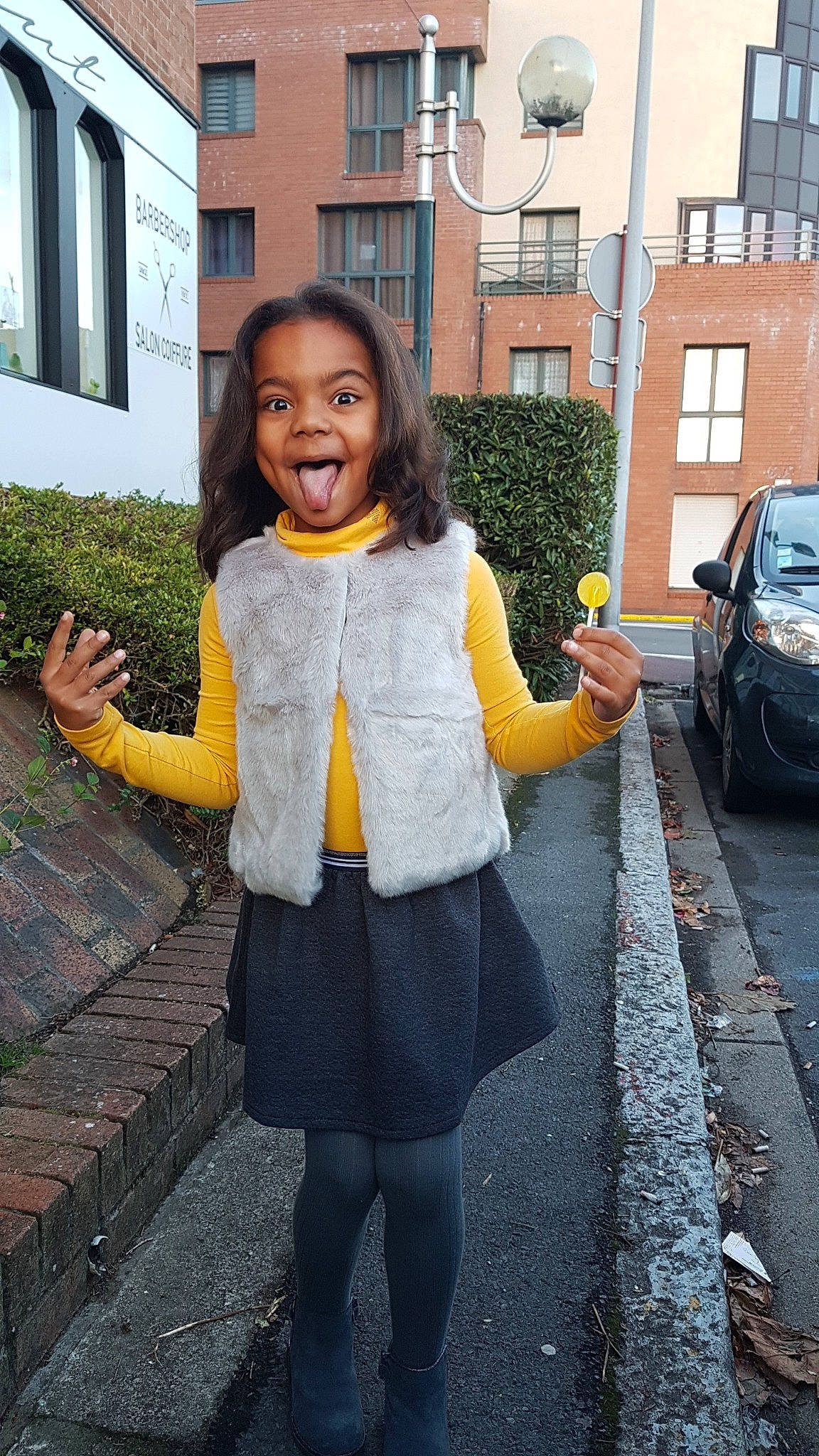 Nayeli participe au concours pour gagner de l'argent avec cette photo : child, clothing, day, denim, facial_expression, fun, girl, infrastructure, jacket, jeans, outerwear, pattern, person, photograph, road, shoulder, smile, snapshot, standing, street