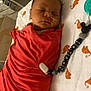 newborn, baby, swaddled, blanket, hospital, medical_tube, sleeping, pacifier, beads, elephant_pattern, infant, bed, resting, cute, indoors, healthcare, child, person, closeup, peaceful
