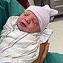 newborn, baby, hospital, blanket, hat, sleeping, swaddled, person, arm, wristband, medical, indoor, healthcare, infant, skin, clothing, bedroom, furniture, care, rest