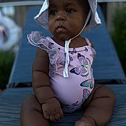 Nova is registered to the contest to win money with this photo: baby, child, infant, swimsuit, hat, butterfly, outdoor, sunhat, lounge_chair, skin, portrait, summer, cute, serious, sitting, toddler, young_child, daylight, fashion, vacation