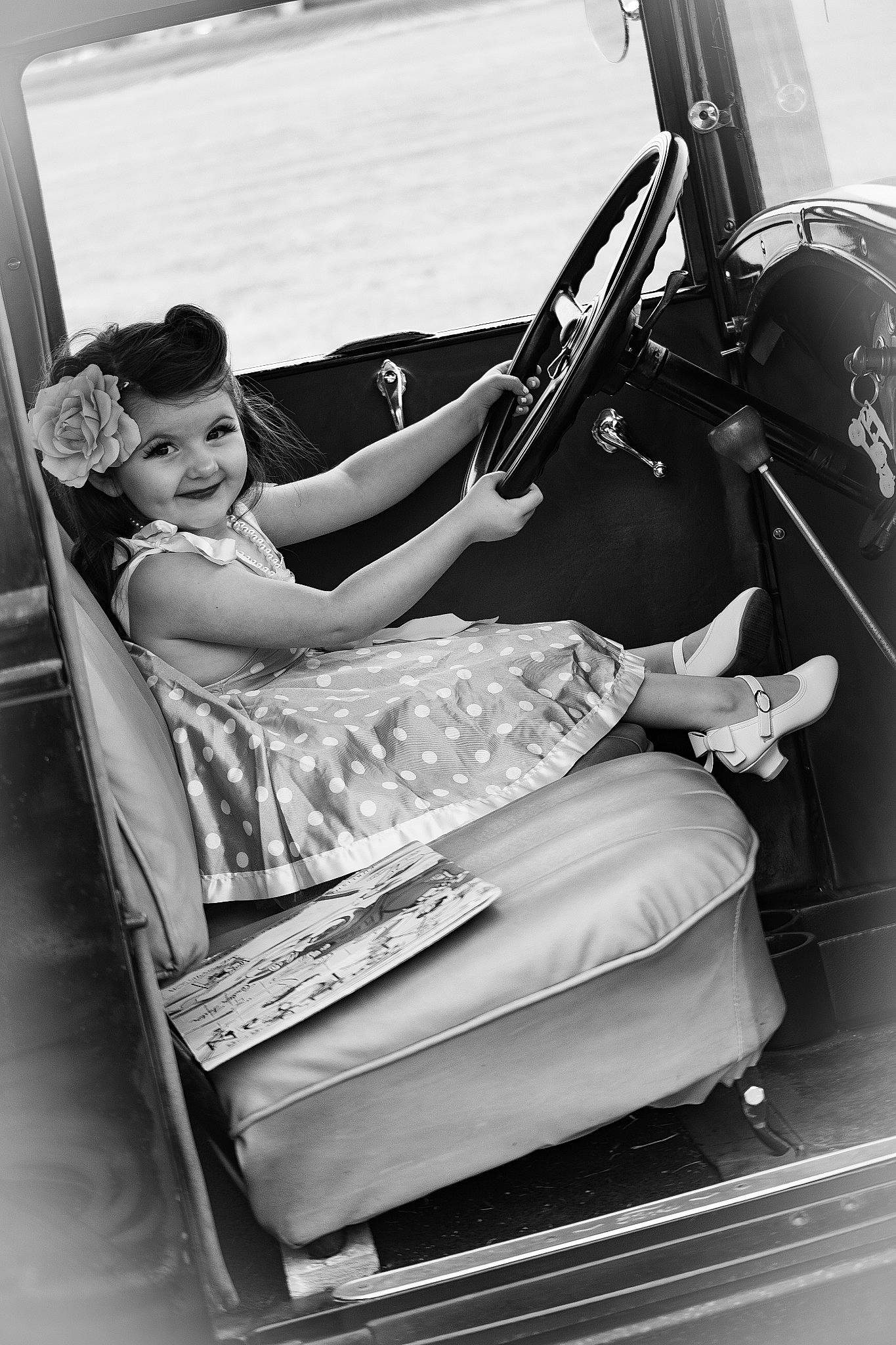 Adaylia is registered to the contest to win money with this photo: automotive_design, black, black_and_white, classic, comfort, dress, flash_photography, human_leg, joy, leg, monochrome, monochrome_photography, motor_vehicle, person, personal_luxury_car, shoe, steering_wheel, style, thigh, tints_and_shades