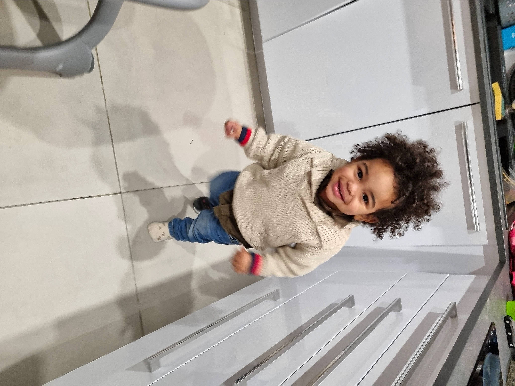 Hayden participe au concours pour gagner de l'argent avec cette photo : baby_toddler_clothing, child, flooring, fun, glass, hoodie, jacket, joy, leisure, person, smile, snapshot, tire, toddler, transport, vehicle, wheel, window, winter, wood