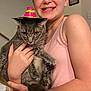 Taco Bell joined the competition — help win amazing prizes! girl, child, cat, gray_cat, sombrero, hat, indoor, smiling, happy, holding, pet, animal, portrait, tank_top, furniture, photo_frame, home, cute, young, funny