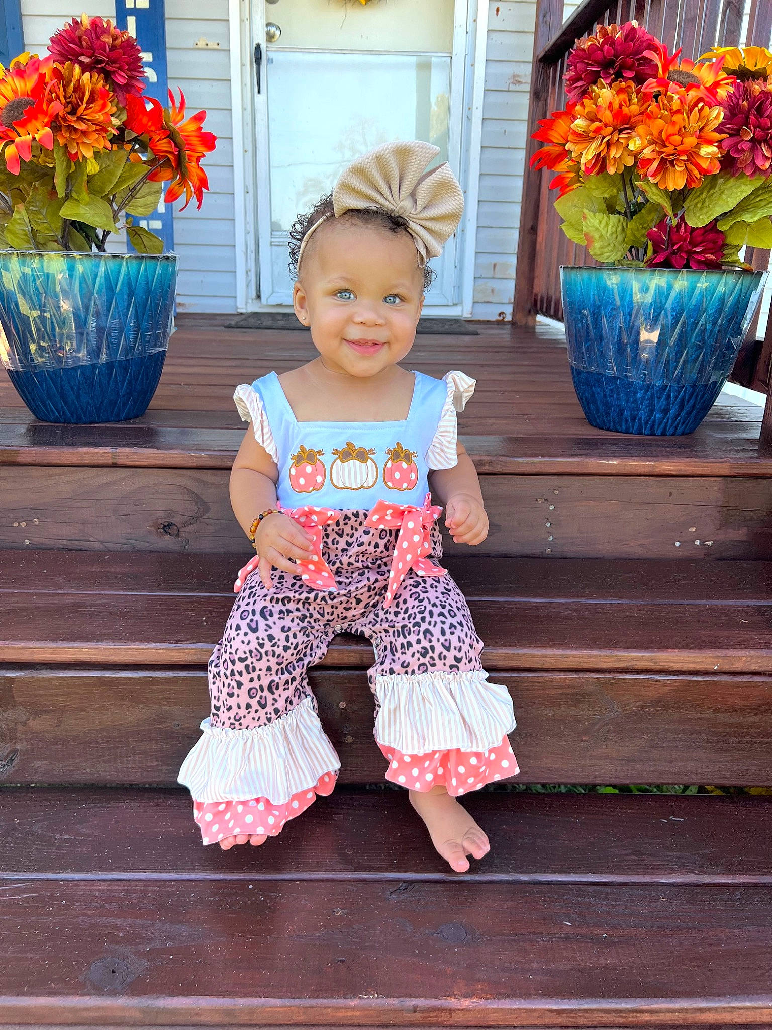 Teagan is registered to the contest to win money with this photo: baby_toddler_clothing, blue, child, dress, flower, flowerpot, foot, fun, happy, head, houseplant, joy, orange, person, pink, plant, red, smile, summer, toddler
