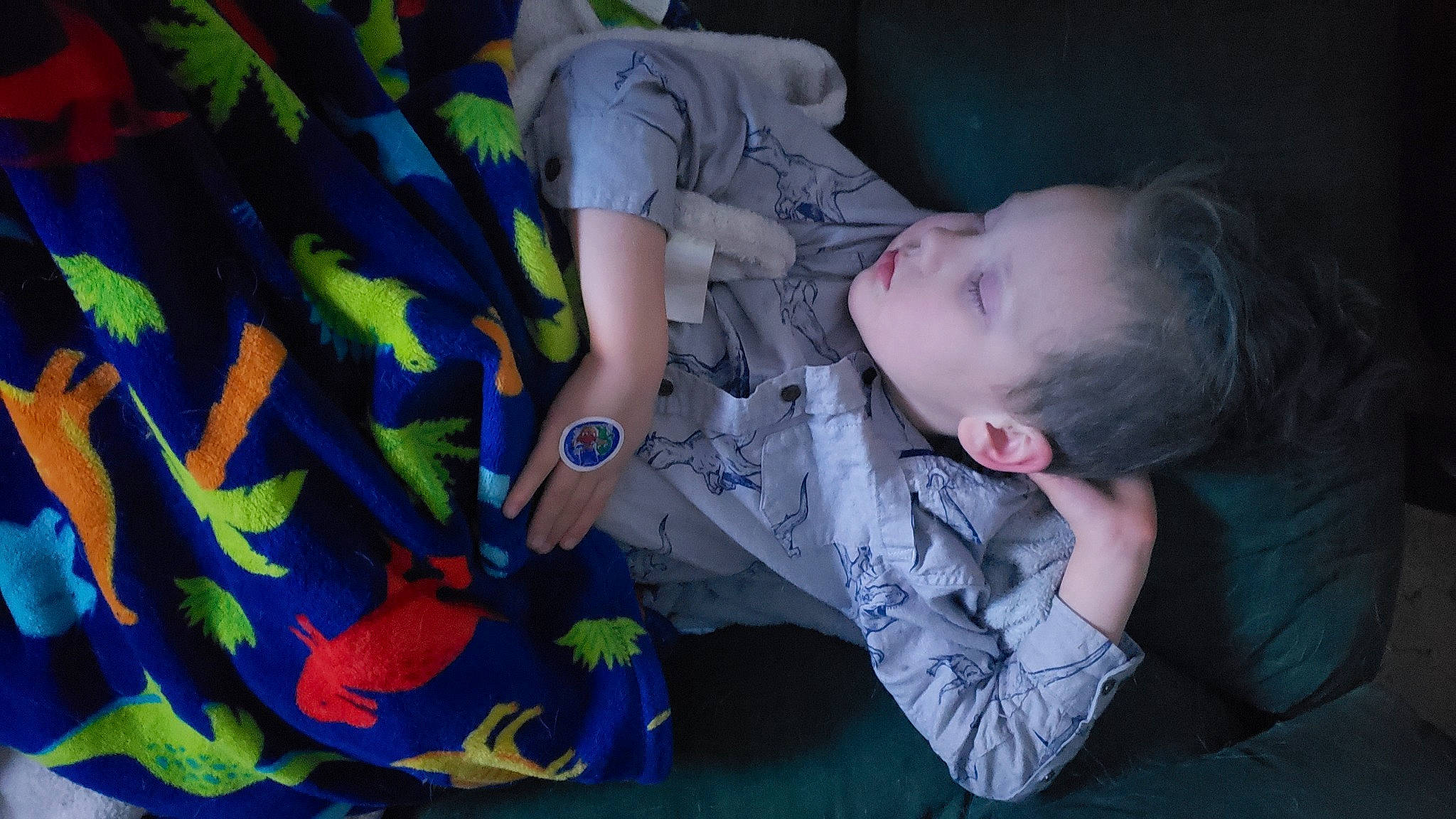 Merlin is registered to the contest to win money with this photo: baby, baby_products, baby_toddler_clothing, baby_toys, bedtime, child, comfort, electric_blue, fun, hand, lap, linens, mouth, nap, pattern, person, room, sitting, sleep, t_shirt