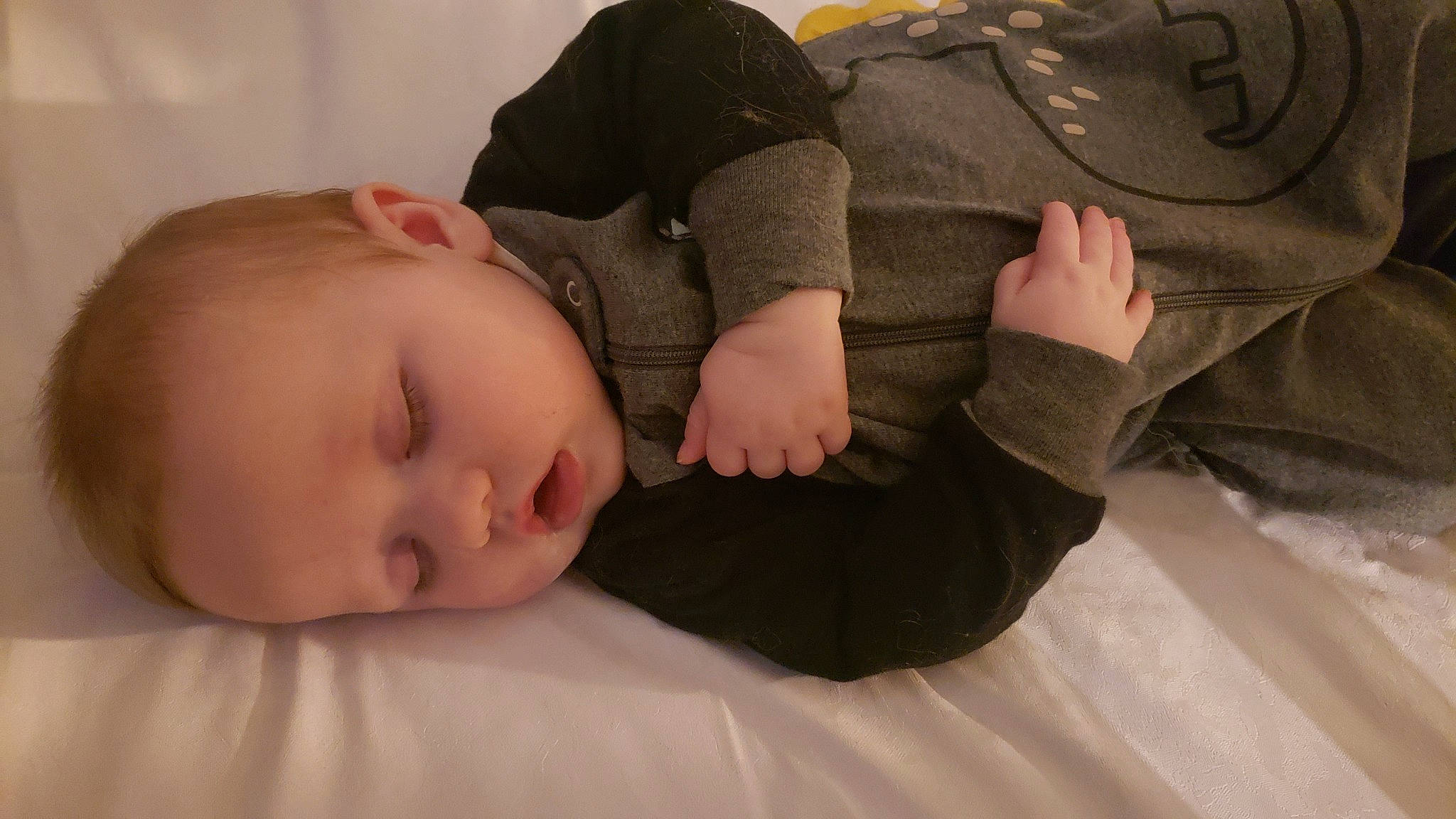 Eivor is registered to the contest to win money with this photo: baby, baby_toddler_clothing, cheek, comfort, facial_expression, finger, flash_photography, flooring, gesture, hand, human_leg, joint, knee, linens, neck, sitting, skin, sleeve, toddler, wood